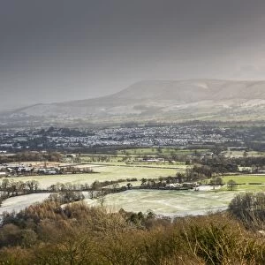 View across snow covered farmland, looking towards Clitheroe from Longridge Fell, Forest of Bowland, Lancashire