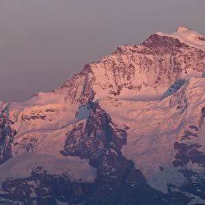 View of snow covered mountain summit at sunset, Jungfrau, Swiss Alps, Bernese Oberland, Switzerland, may