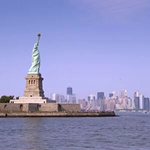 View of Statue of Liberty, with Manhattan Island city skyline in distance, Liberty Island, New York Harbor