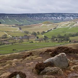 View of upland farmland and moorland habitat with patches of snow along drystone walls, looking from Danby Rigg