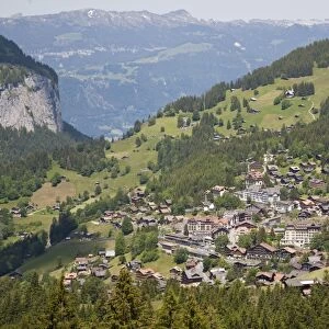 View of village in mountain valley, Wengen, Bernese Alps, Switzerland, June