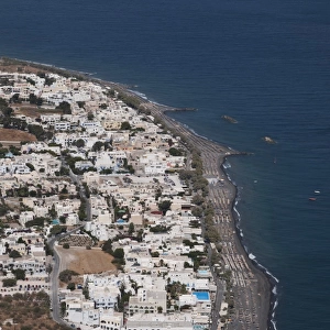 View of village and volcanic beach, Kamari, Santorini, Cyclades, Aegean Sea, Greece, September