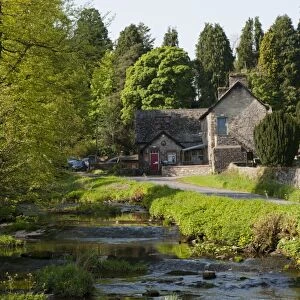 Village primary school beside river in rural setting, Ravenstonedale, Westmorland, Cumbria, England, May