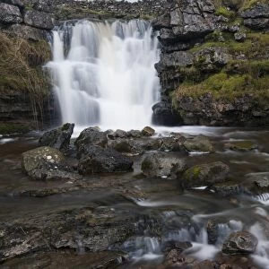 Waterfall on limestone outcrop, Ravenstonedale, Cumbria, England, December