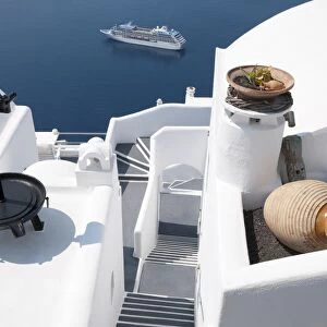 White-washed villa hotel building and cruise ship at sea, Fira, Santorini, Cyclades, Aegean Sea, Greece, September