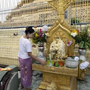 Woman beside altar in front of stupa, Botahtaung Pagoda (Buddhas First Sacred Hair Relic Pagoda), Yangon, Myanmar