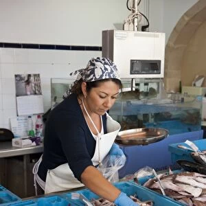 Woman selling freshly landed fish on market stall, Xabia, Alicante Province, Valencia, Spain, May
