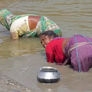 Woman subsistence fishing by touch of hand, Sundarbans, Ganges Delta, West Bengal, India, March Woman subsistence fishing by touch of hand, Sundarbans, Ganges Delta, West Bengal, India, March