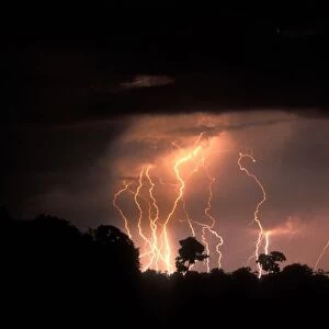 Botswana, Moremi Game Reserve, Lightning fills sky over Khwai River at end of dry