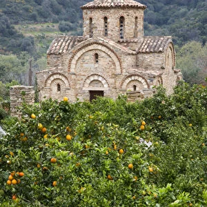 Crete. Greece. Europe. Grove of orange trees & Church of the Panayia. Byzantine church near Fodele