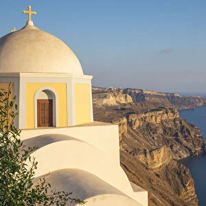 Domed church with steeple in town of Fira, Santorini, Greece
