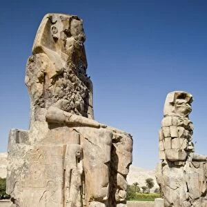 Egypt, Thebes. The six-story-high faceless Colossi of Memnon were badly damaged by