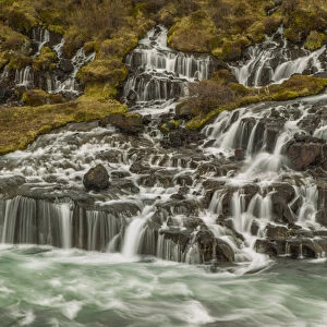Europe, Iceland, Hraunfossar. Waterfalls flow over igneous rocks into stream. Credit as