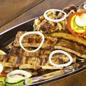 Plate with many types of different grilled meat, pork chops, spare ribs, sausages