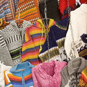 Sweaters and ponchos on display at market, Plaza de San Francisco, Cuenca, Ecuador
