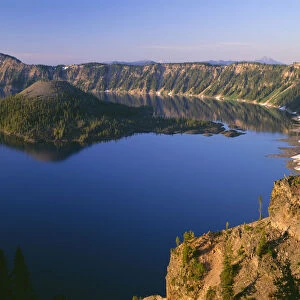 USA, Oregon, Crater Lake National Park. Sunrise light on Wizard Island, view south
