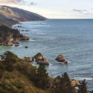 View south of Big Sur coastline with little arch rock in Ocean waters