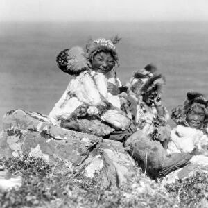 ALASKA: ESKIMOS, c1929. Four Eskimo children sitting on the edge of cliff, dressed