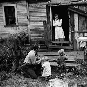 COAL MINERs FAMILY, 1938. A coal miner and his family at their home in Bertha Hill