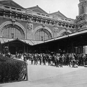 ELLIS ISLAND, c1910. Newly arrived immigrants waiting outside of the main building