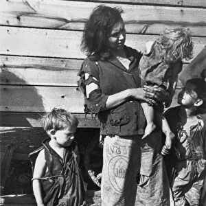 MIGRANT FAMILY, 1936. A mother and children at a migrant worker camp on U