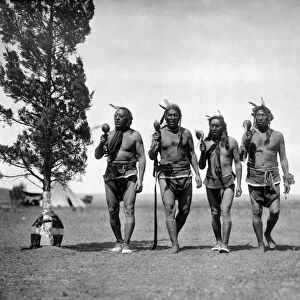 NIGHT MEDICINE MEN, c1908. A group of four night medicine men of the Arikara tribe walking together, in traditional dress. Photographed by Edward S. Curtis, c1908