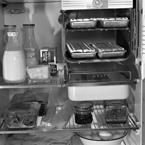 REFRIGERATOR, 1942. Demonstrating the proper way to arrange food in a refrigerator