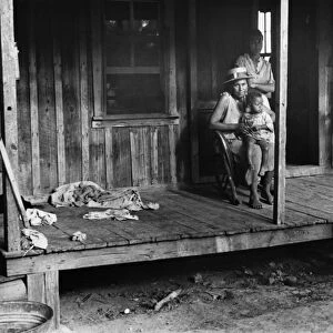SHARECROPPER FAMILY, 1935. A family of sharecroppers outside their home in Little Rock, Arkansas