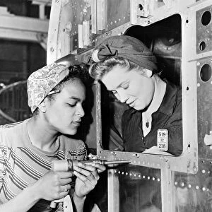 Two women at work at the Douglas Aircraft Company factory in California, during World War II