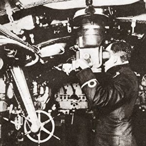 WORLD WAR I: SUBMARINE. An officer looking through a periscope on a submarine during World War I