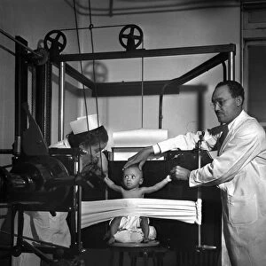 X-RAY MACHINE, 1942. A baby being x-rayed at the Provident Hospital in Chicago, Illinois