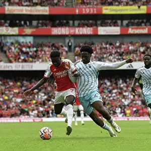 Arsenal's Bukayo Saka Faces Off Against Nottingham Forest's Ola Aina in 2023-24 Premier League Clash