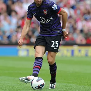Arsenal's Carl Jenkinson Faces Off Against Stoke City in 2012-13 Premier League Clash