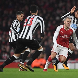 Arsenal's Jack Wilshere Clashes with Newcastle's Midfield Trio during Premier League Match