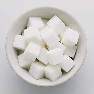 Bowl of white sugar cubes, view from above