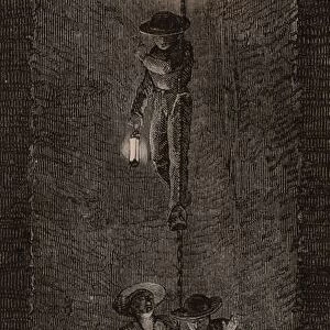 Coal miners, carrying their safety lamps, being lowered down the pit shaft on a chain