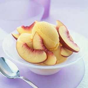 Dish of sorbet topped with slices of nectarine