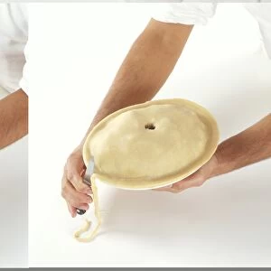 Image of pastry being to the shape of Pie Dish with a knife