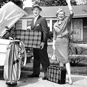 Mature couple loading car trunk for a trip