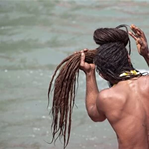 Naga sadhu coming out of the river Ganges on the occasion of Somvati Amavasya, a no moon day in the traditional Hindu calendar