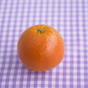 Orange on purple gingham surface
