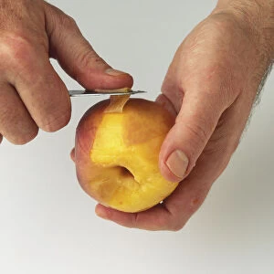 Peach being peeled with knife