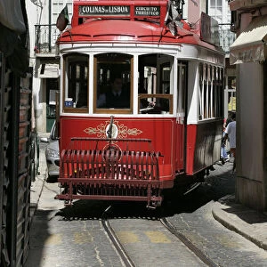 Portugal, Lisbon, red tourist tram on narrow road
