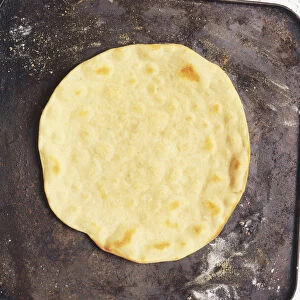 Round, flat pancake-like white bread, cooked on griddle