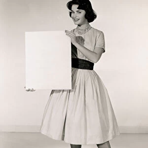 Woman holding up blank sheet of paper