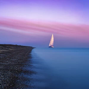 A large sailing boat of the Isle of Sheppey at sunrise, Kent. UK