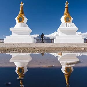 A photographer with tibetan stupas