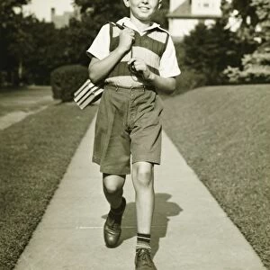 Teenage boy (13-14) going to school, suburbs, (B&W)