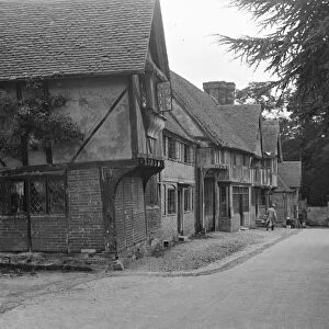A bus in the village of Chiddingstone, Kent, showing the old cottages