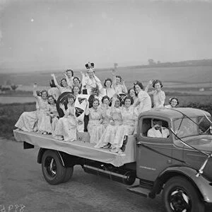 The Dartford Carnival Queen with her attendees parade on a lorry. 1938
